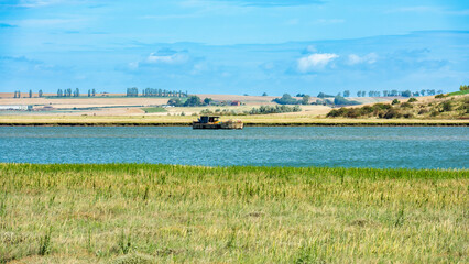 Wrecked Boat in the Swale Estuary in Oare near Faversham - Kent with the Isle of Sheppey in the...