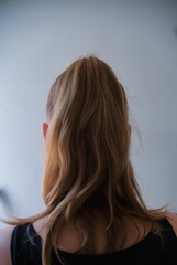 long hair of a woman from behind, on a white background
