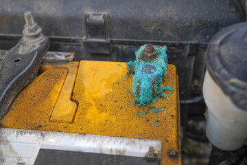 Oxidized and dirty car battery terminal at posts contact from acid leak.
