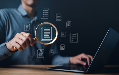 business, document, management, corporate, file, information, laptop, folder, professional, organization. close up to businessman, one hand typing keyboard, another hold magnifier to search document.