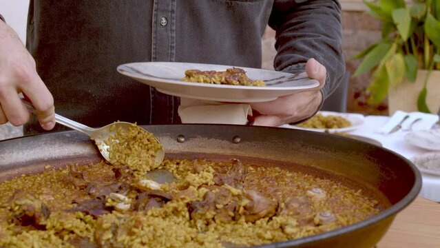 Eating paella with rabbit and snails in a restaurant, Alicante, Spain - stock video