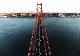 Foto op Canvas Aerial photos of the 25 April bridge (Ponte 25 de Abril) located in Lisbon, Portugal, crossing the Targus river - taken by drone. © Matt Benzero
