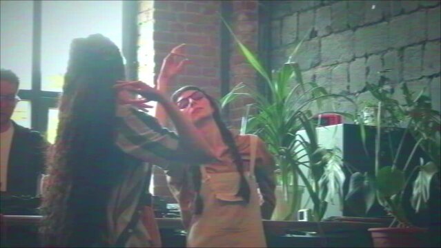 VHS shot of modern young ethnically diverse squatters enjoying dancing to music their friend playing with use of DJ controller