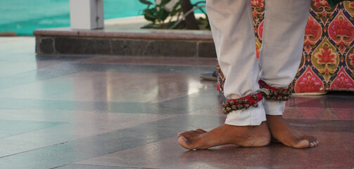 feet with anklet bells on his feet shot