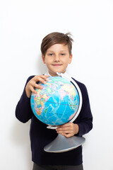 Schoolboy holding globe. Back to school concept. High quality photo