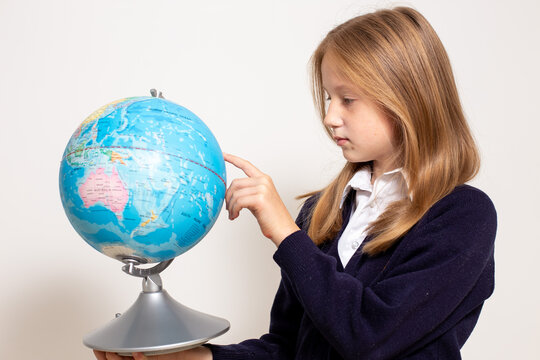 Schoolgirl holding globe. Back to school concept. High quality photo