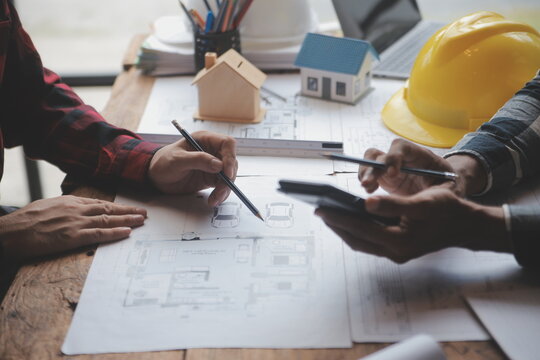 Engineer Teamwork Meeting, Drawing working on blueprint meeting for project working with partner on model building and engineering tools in working site, Construction and structure concept.