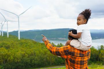 Young African American Girl and Dad Amidst Wind Energy.