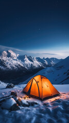 Orange tent on snow high up in the mountains at night
