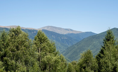 Fototapeta na wymiar Landscape from Baia de Fier, Gorj, Romania. The Parang mountains can be seen in the distance.