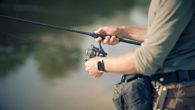 Fisherman catching fish perch on river	