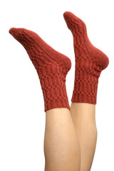 Female legs in terracotta hand knitted wool socks