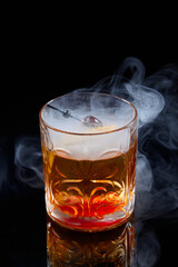 smoked rum Old Fashioned with on black background