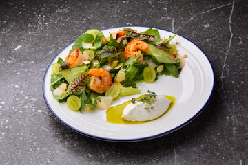fresh healthy shrimps salad with arugula,dried tomatoes and grapes.