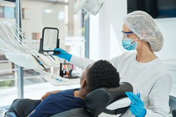 Patient looking at result after dental treatment