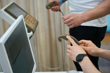Doctor getting patient ready for body composition analysis