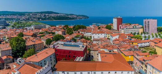 A panorama view west from the clock tower above Tito Square over the rooftops of Koper, Slovenia in summertime