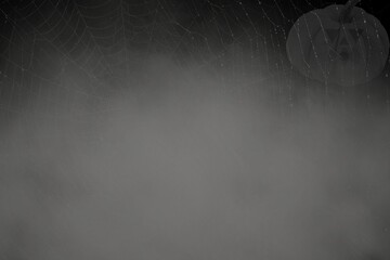 Spider web on black wall, halloween spooky dark night with silhouette pumpkin 
