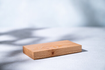 Wooden board empty for product demonstration or mock-up with shadows on a blue background....