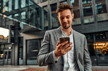 Portrait of an attractive confident modern man holding a phone while making a corporate call....