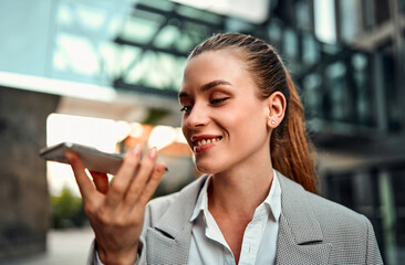 Portrait of a beautiful confident smiling adult professional woman standing against the background...