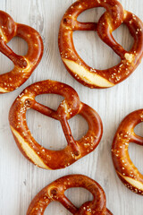Homemade Soft Bavarian Pretzels on a white wooden background, top view.