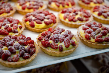 Wild fragolino strawberry and raspberry cakes in ancient city of strawberry Nemi, Castelli Romani, Italy close up