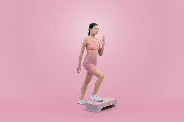 Vigorous energetic woman doing exercise at on studio short isolated background with cardio aerobic step workout. Young athletic asian woman dexterity and endurance training session concept.