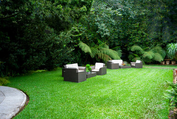 Plastic room installed in outdoor garden, ornamental detail in space covered by grass and old trees. - 642218738