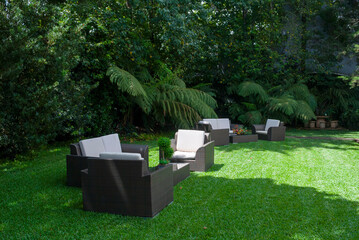 Plastic room installed in outdoor garden, ornamental detail in space covered by grass and old trees. - 642218752