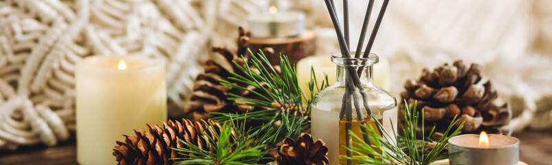 Organic essential oil, pine nuts, cedar cone on rustic wooden dark background. Concept of natural ingredients, naturopathy, herbal extracts and essence. Alternative medicine, aromatherapy banner