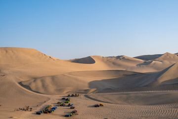 Some 20 colorful sand cars in the middle of the sand dunes
