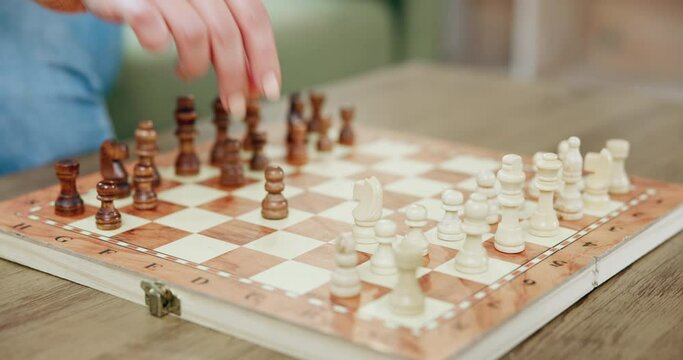 Chess, hands and knight in a home with pawn, board game and strategy development plant. Table, chessboard and competition with planning a contest move with challenge of people playing in a house