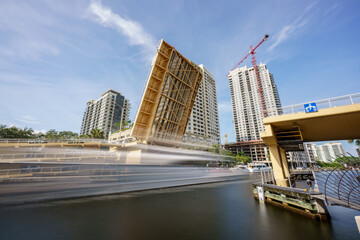 Long exposure motion blur yacht passing under a drawbridge Fort Lauderdale FL New River