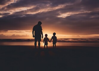 silhouettes of people walking on the beach at sunset