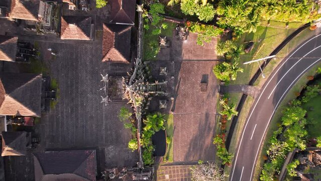 Drone flight top down at an authentic temple Batusepih near Ubud village at Bali island, Indonesia.
Exotic culture in paradise. Aerial at the beautiful sunset.