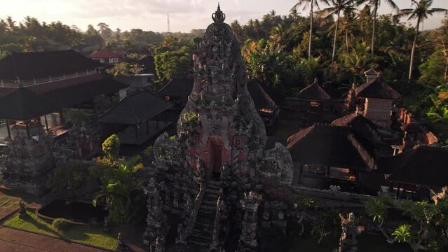 Drone flight around an authentic temple Batusepih near Ubud village at Bali island, Indonesia.
Exotic culture in the paradise. Aerial at the beautiful sunset.