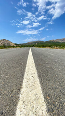 Straight asphalt road and natural landscape