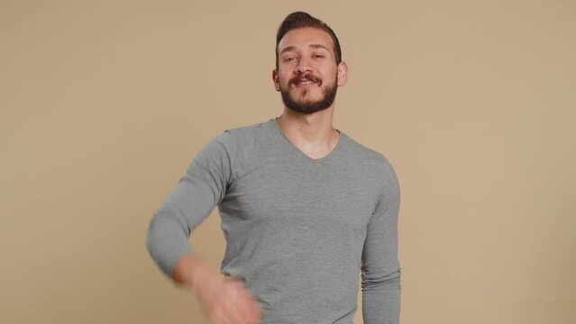 Ok. Joyful happy lebanese man in long sleeve looking approvingly at camera showing approve feedback gesture like sign positive something good. Handsome guy on beige background. People sincere emotion