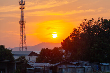 Amazing sky at sunset. Gradient color. Sky texture, abstract nature background..Sunset with red color light rays and other atmospheric effects..Big sunset and sweet lighting sky. phone antenna post.
