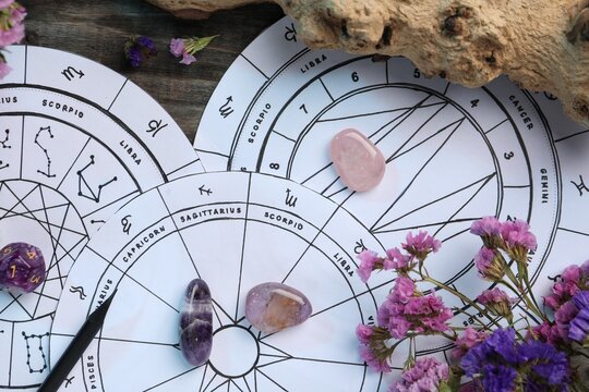 Flat lay composition with zodiac wheels and astrology dices on wooden table