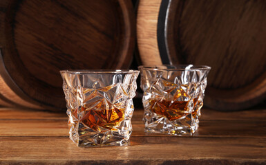Glasses of whiskey on wooden table. Space for text