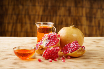 Pomegranates and pomegranate wine on a simple background