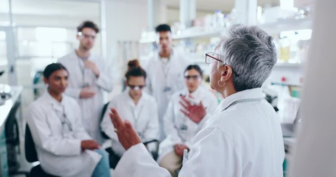 Senior woman, scientist and training students in meeting, planning or teaching interns at laboratory. Mature female person, leader or mentor in team discussion, strategy or ideas in research at lab