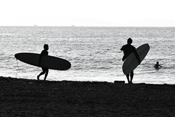Surfers on the beach. Sea sport leisure background image.