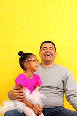 Obraz premium Divorced single dad and 4 year old brunette Latina daughter dressed as a ballerina spend time together show their love and happiness