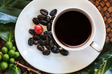 Top view of black coffee in isolated cup with coffee beans