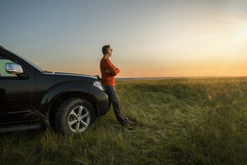 man enjoying time evening travelling by vehicle at sunset. concept of tourism travel and male...