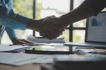 Business success. Businesspeople shake hands to confirm agreements to do business together and invest in companies to collect capital to expand new companies.