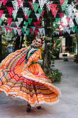 Latin woman dancer wearing traditional Mexican dress traditional from Guadalajara Jalisco Mexico...